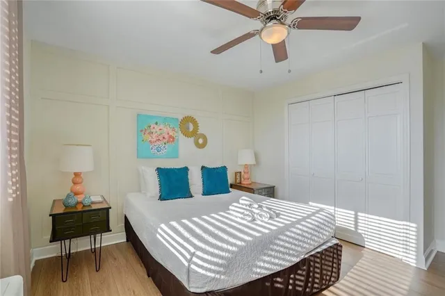 a bedroom with a bed and wooden floor