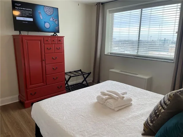 a bedroom with a bed and a dresser
