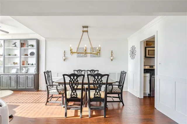 a view of a dining room with furniture wooden floor and kitchen