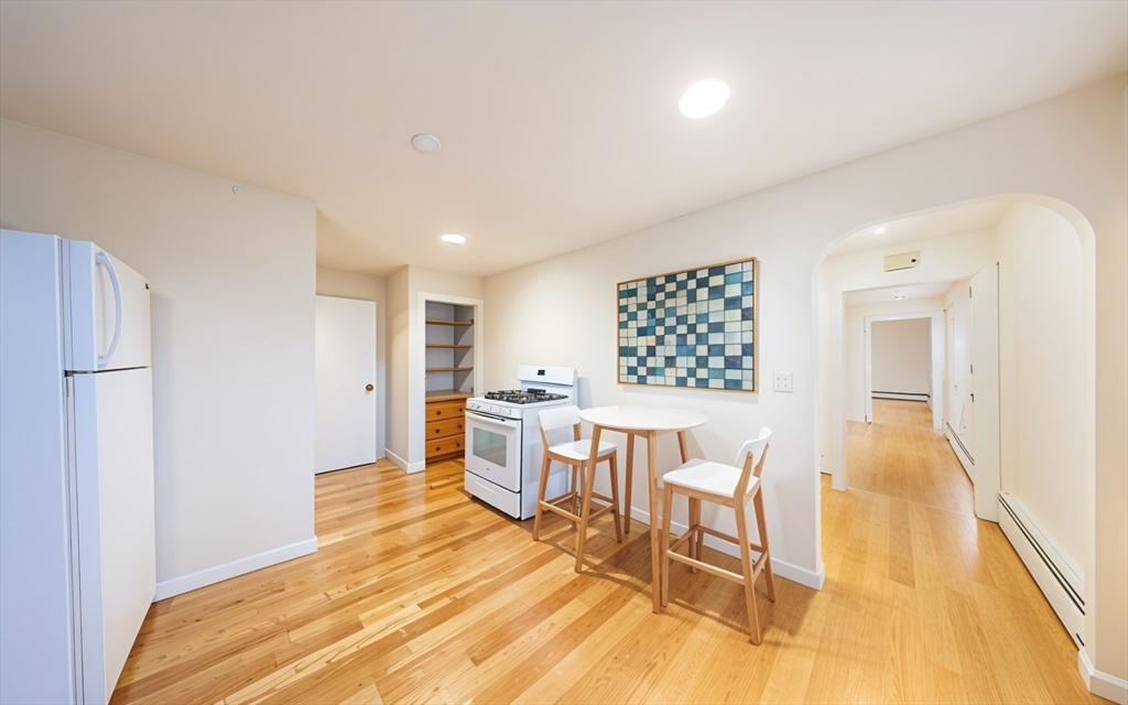 1026 Chestnut Street, Unit 2A Newton, MA 02464 - Photo 1 of 17 a bed room with a chair and table in it