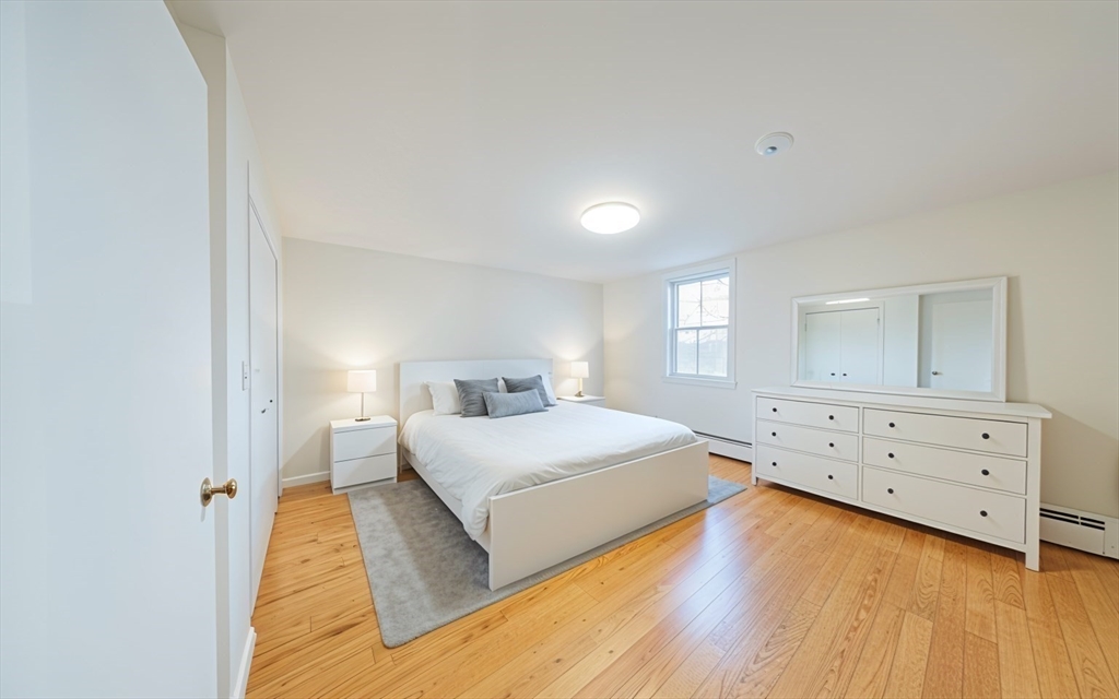 1026 Chestnut Street, Unit 2A Newton, MA 02464 - Photo 14 of 17 a bedroom with a bed and a dresser