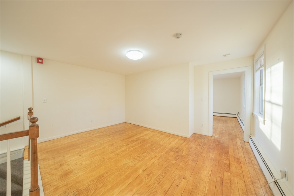 1026 Chestnut Street, Unit 2A Newton, MA 02464 - Photo 10 of 17 a view of empty room with wooden floor and fan