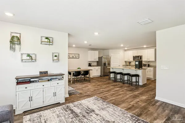 a kitchen with stainless steel appliances kitchen island granite countertop a sink and cabinets