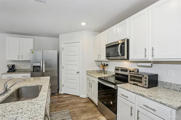 a kitchen with a sink stove and refrigerator