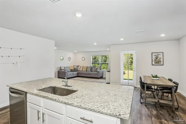 a kitchen with sink refrigerator and dining table