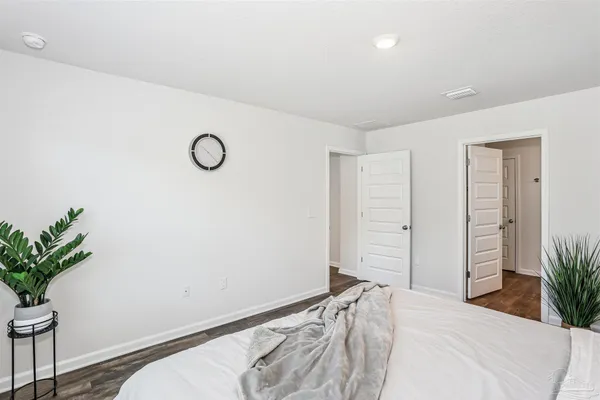 a bedroom with a bed and a potted plant