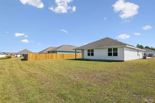 a yellow house with yard in front of it