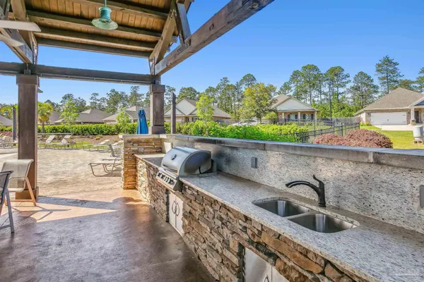 a kitchen with large window a sink and a counter top space