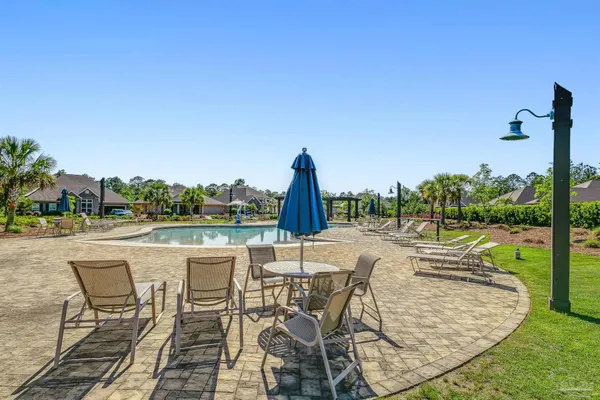 a view of a swimming pool with outdoor seating and plants