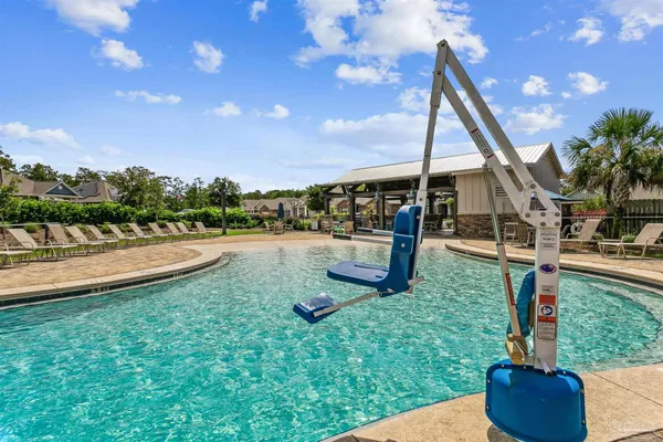 a view of a swimming pool with a patio and a yard