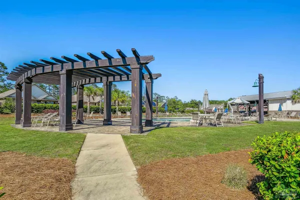 a view of a house with a big yard and a large tree