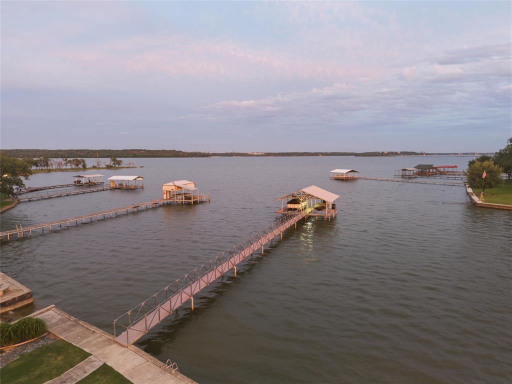 6625 Sandy Beach Road Azle, TX 76020 - Photo 5 of 40 Lake view showcases expansive waterfront views with surrounding shoreline visibility and direct dock access extending into the lake. Open water views and landscaped shoreline areas create a wide exterior waterfront setting.
