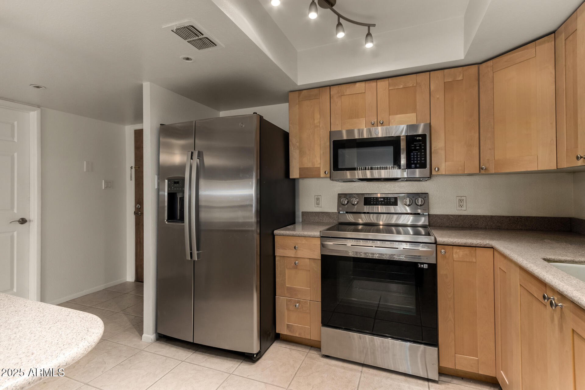 7850 East Camelback Road, Unit 101 Scottsdale, AZ 85251 - Photo 1 of 26 a kitchen with a stove and a microwave