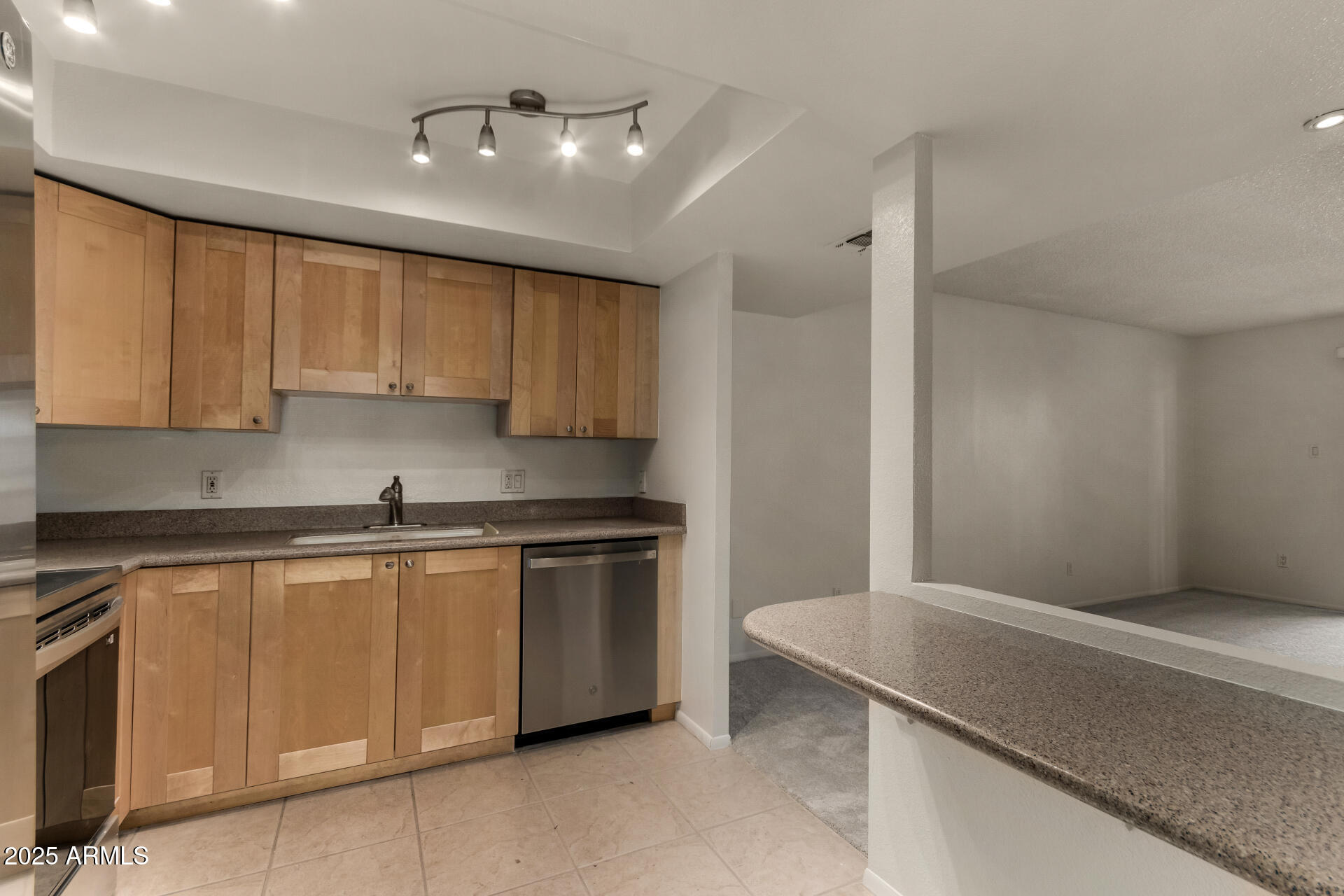 7850 East Camelback Road, Unit 101 Scottsdale, AZ 85251 - Photo 10 of 26 a kitchen with stainless steel appliances granite countertop a sink and cabinets