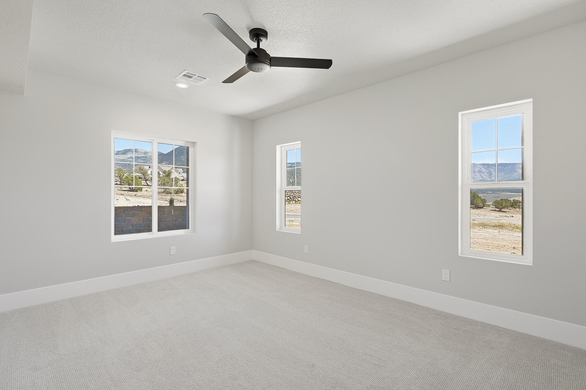 1852 South Hidden Canyon Road Cedar City, UT 84720 - Photo 52 of 79 The natural slope of the lot creates an above-grade feel in this basement bedroom, with windows looking directly out to the surrounding landscape.