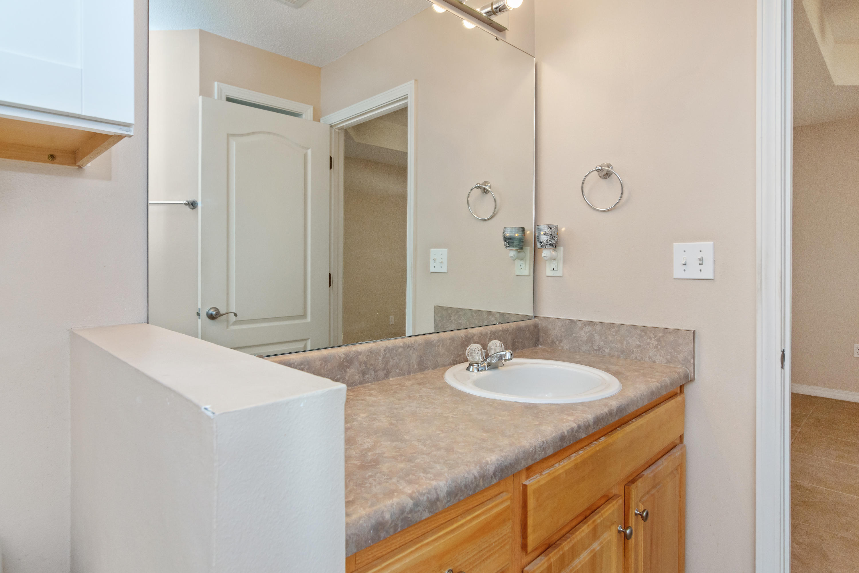 3811 Poverty Creek Road Crestview, FL 32539 - Photo 14 of 48 a bathroom with a granite countertop sink and a mirror