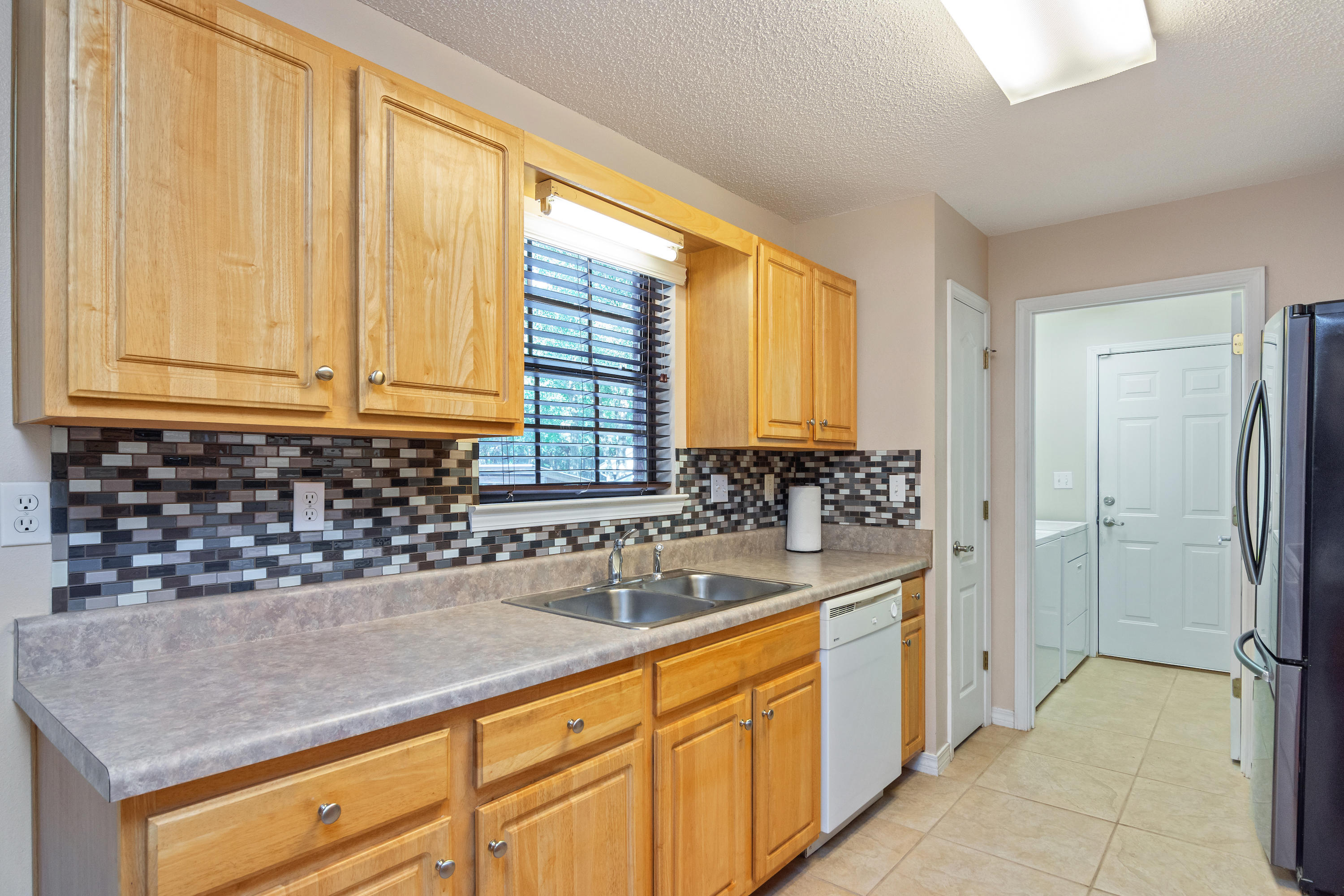 3811 Poverty Creek Road Crestview, FL 32539 - Photo 20 of 48 a kitchen with a sink and cabinets