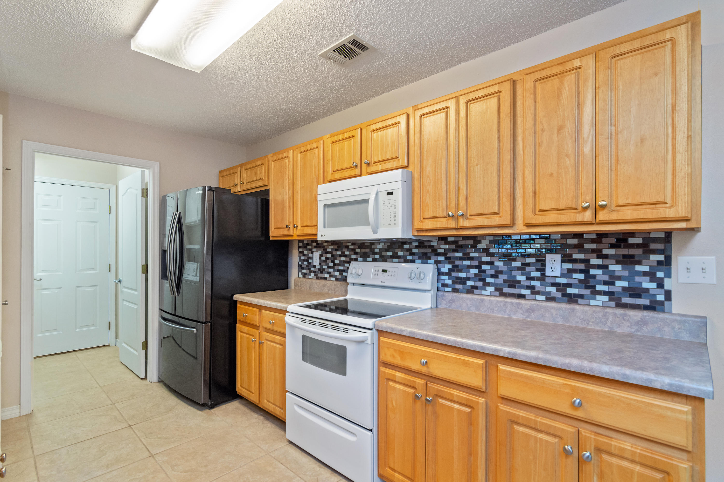 3811 Poverty Creek Road Crestview, FL 32539 - Photo 21 of 48 a kitchen with stainless steel appliances granite countertop a stove a refrigerator and a sink