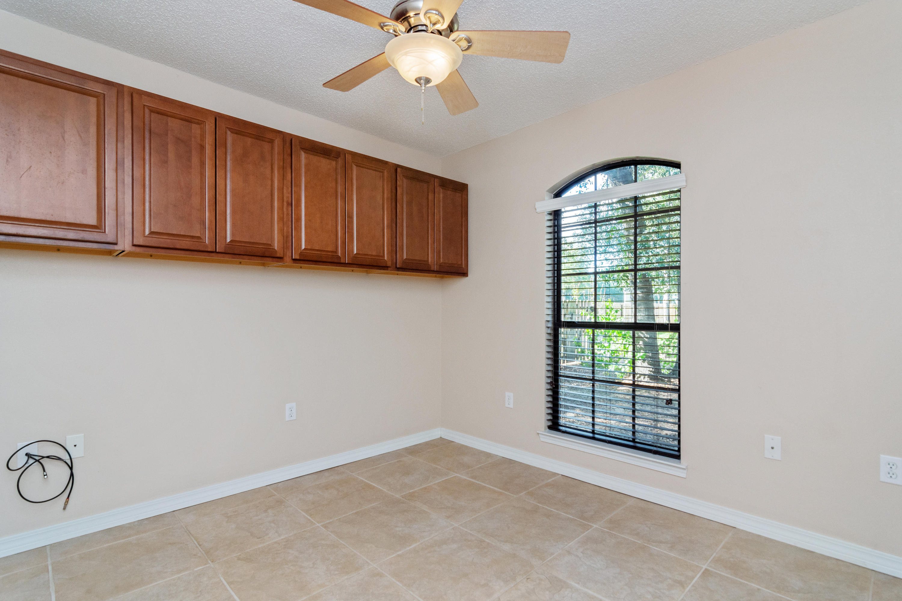 3811 Poverty Creek Road Crestview, FL 32539 - Photo 28 of 48 an empty room with windows and fan