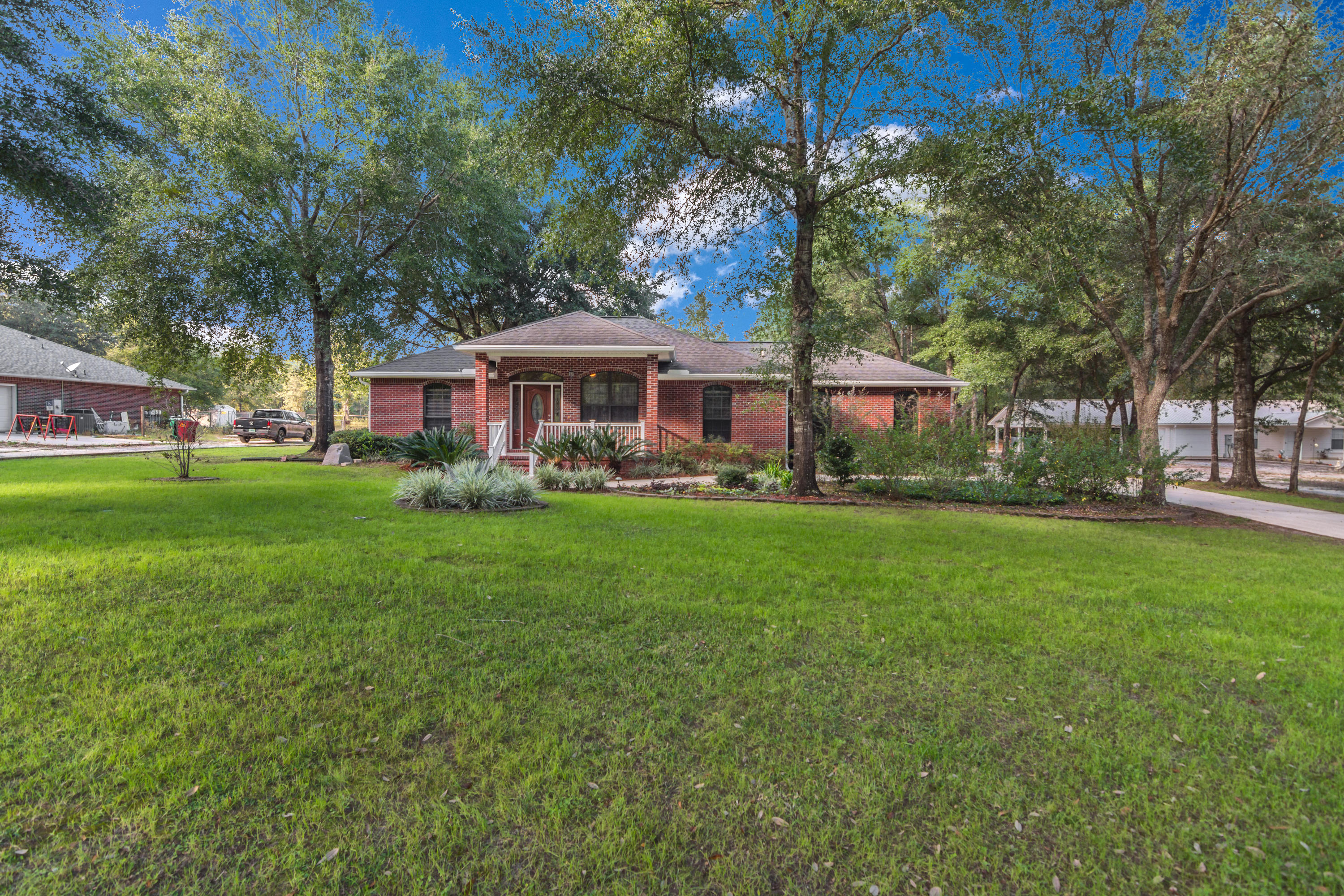 3811 Poverty Creek Road Crestview, FL 32539 - Photo 3 of 48 a front view of a house with garden