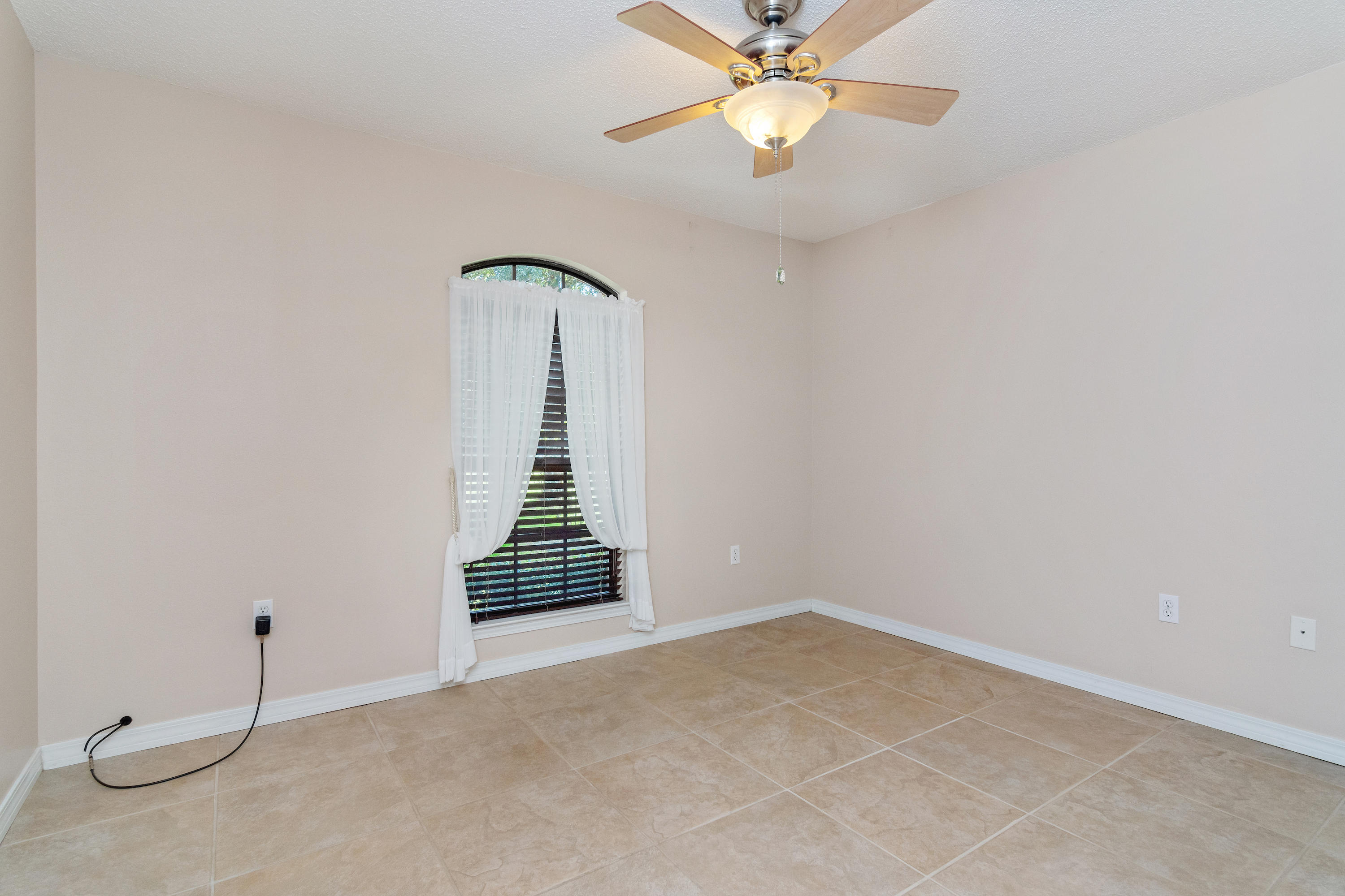 3811 Poverty Creek Road Crestview, FL 32539 - Photo 31 of 48 an empty room with windows and fan