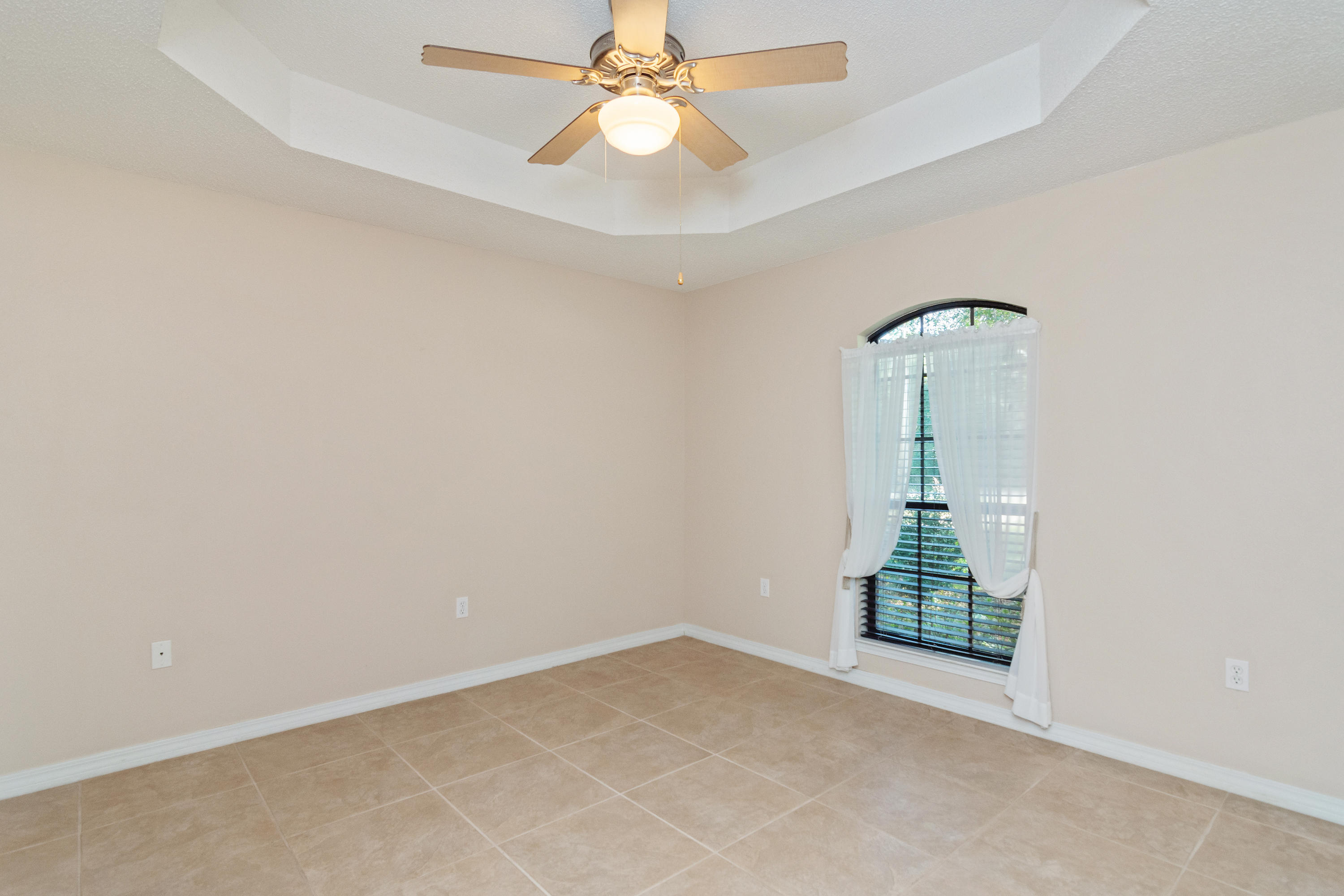 3811 Poverty Creek Road Crestview, FL 32539 - Photo 10 of 48 an empty room with chandelier fan and windows