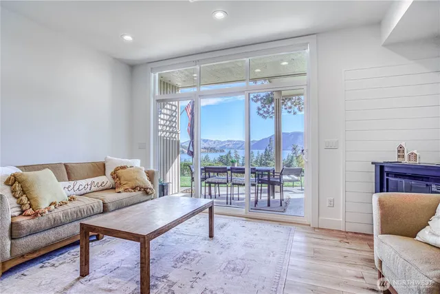 a living room with furniture and a floor to ceiling window
