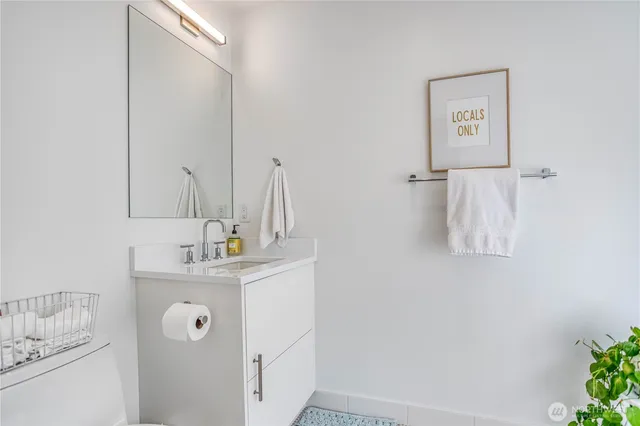 a bathroom with a sink vanity and mirror