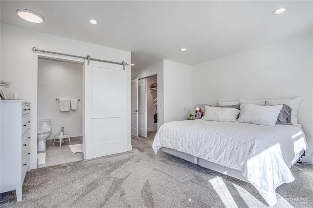 a spacious bedroom with a bed and a table