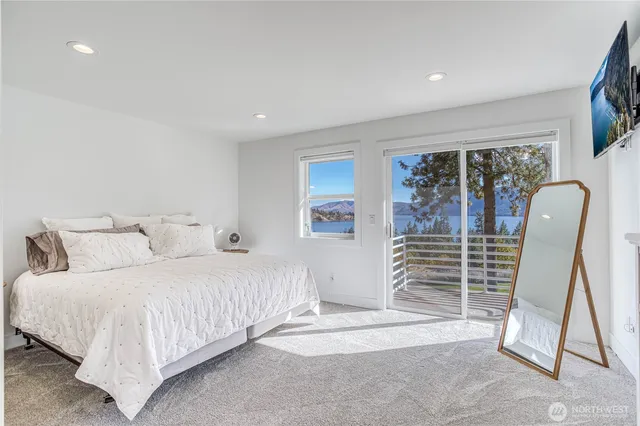 a bedroom with a bed a couch and a window