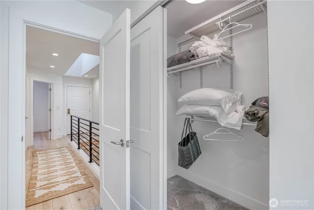 a view of a hallway with windows and cabinet