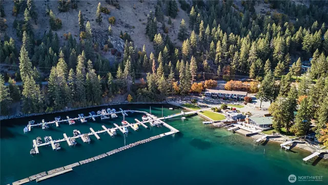 a view of swimming pool with chairs and trees