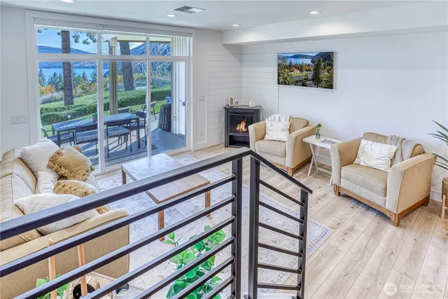 a living room with furniture and a floor to ceiling window