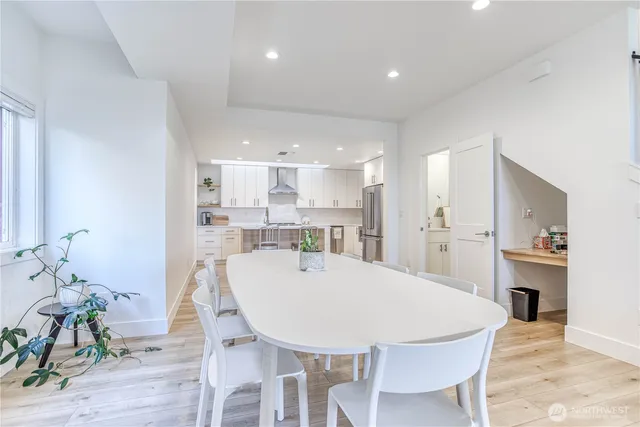 a large kitchen with a table and chairs