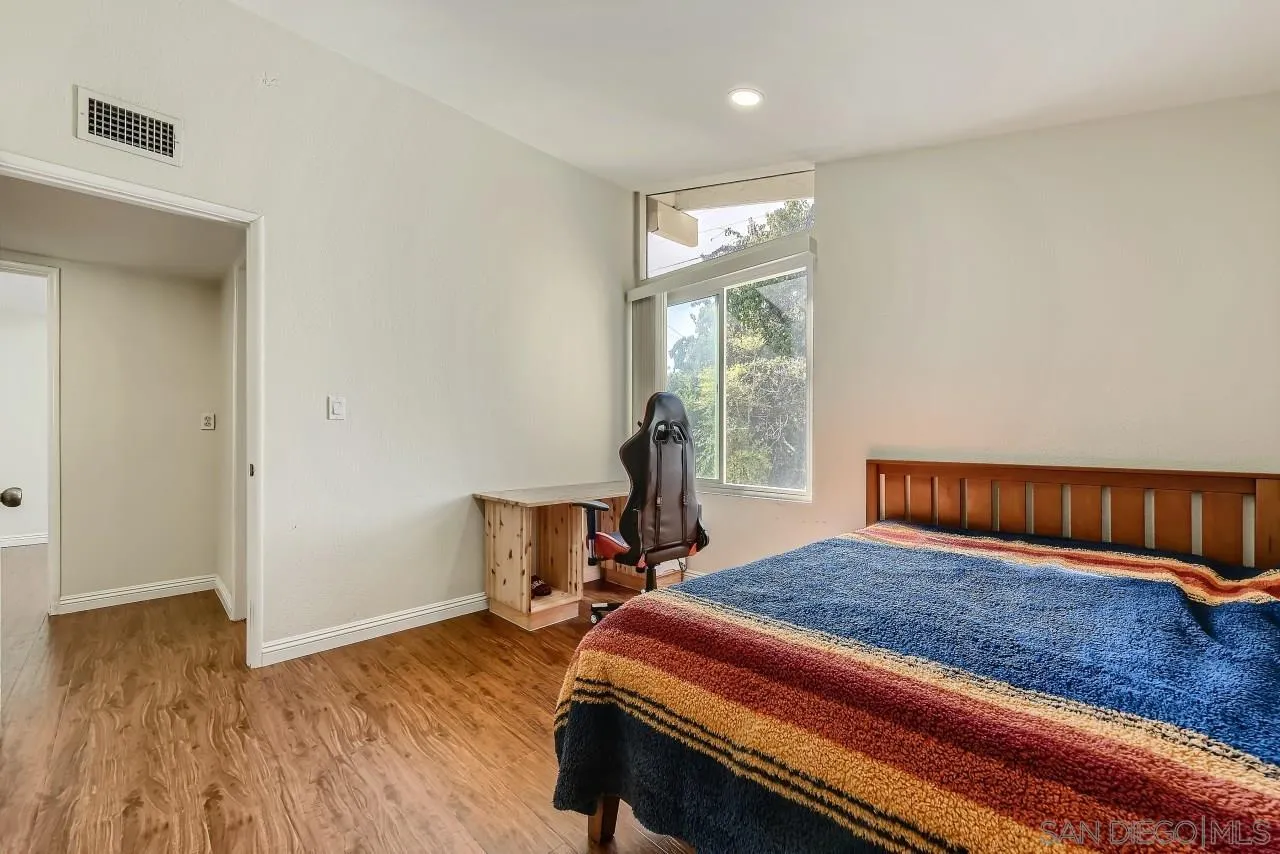 13847 Tobiasson Road Poway, CA 92064 - Photo 17 of 28 a bedroom with a bed and wooden floor