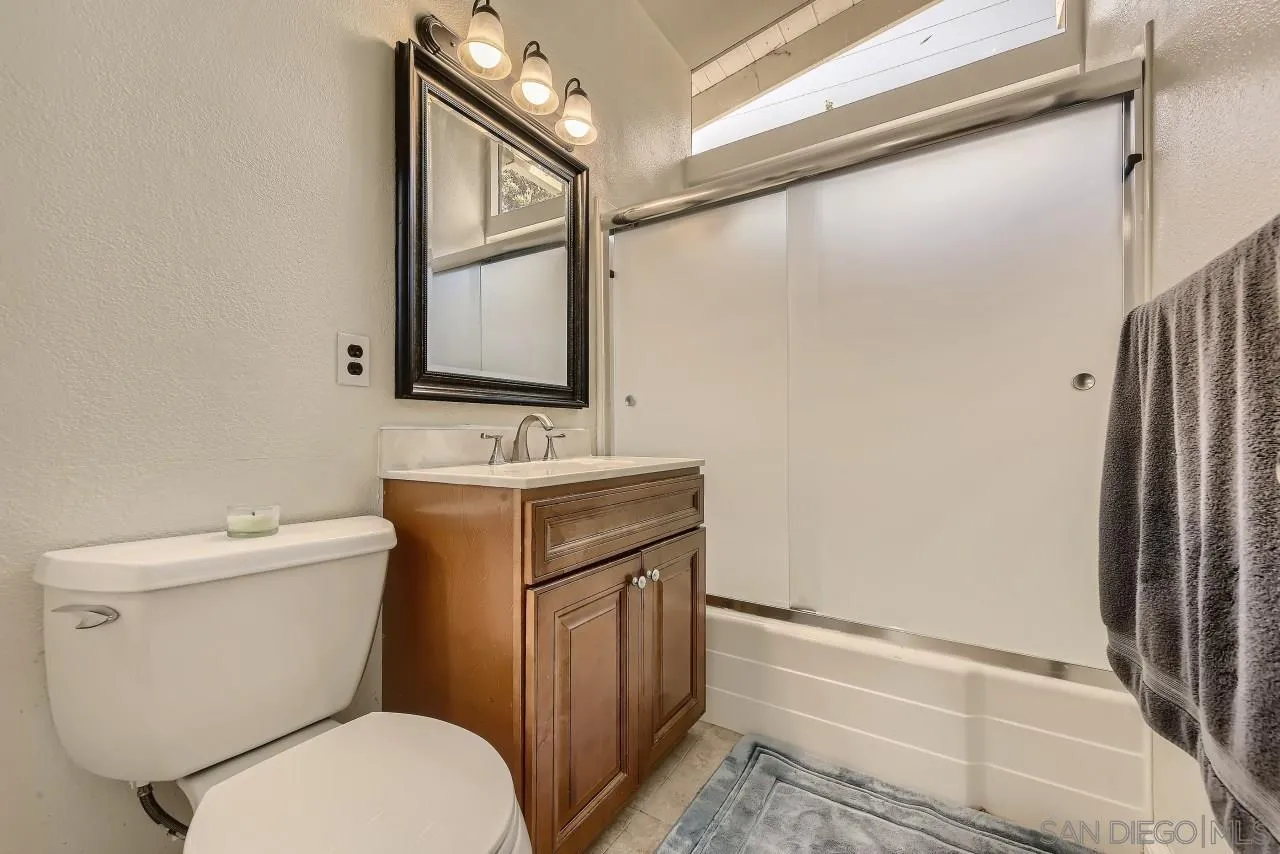 13847 Tobiasson Road Poway, CA 92064 - Photo 20 of 28 a bathroom with a toilet sink and mirror