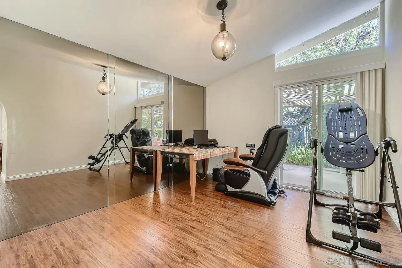 13847 Tobiasson Road Poway, CA 92064 - Photo 9 of 28 a view of a workspace with furniture and a chandelier