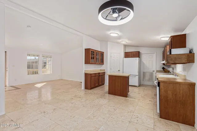 a view of kitchen with stainless steel appliances granite countertop cabinets and window