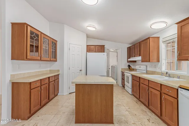 a large kitchen with stainless steel appliances granite countertop a sink and cabinets
