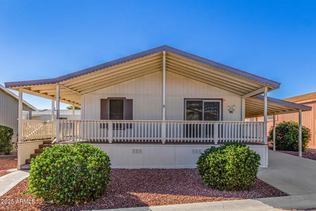 a view of a house with a small yard and wooden fence
