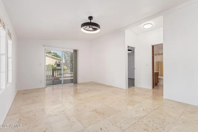 an empty room with windows and closet