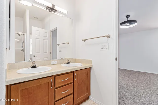 a bathroom with a sink double vanity and a mirror