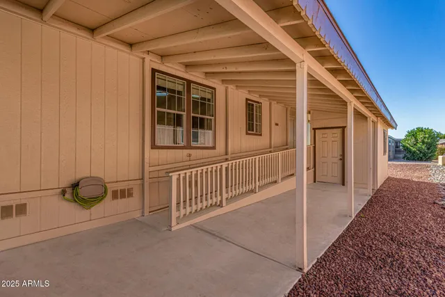a view of a porch with wooden floor and fence