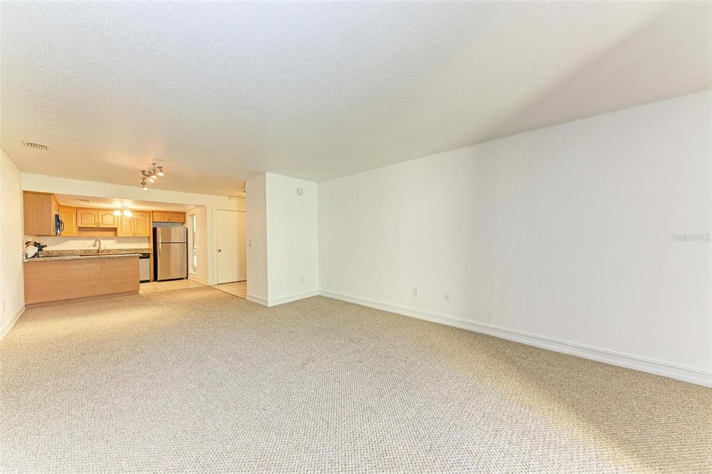 3411 Clark Road, Unit 212 Sarasota, FL 34231 - Photo 12 of 20 a view of a livingroom and a kitchen with furniture