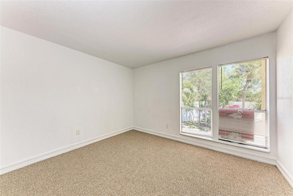 3411 Clark Road, Unit 212 Sarasota, FL 34231 - Photo 13 of 20 an empty room with windows