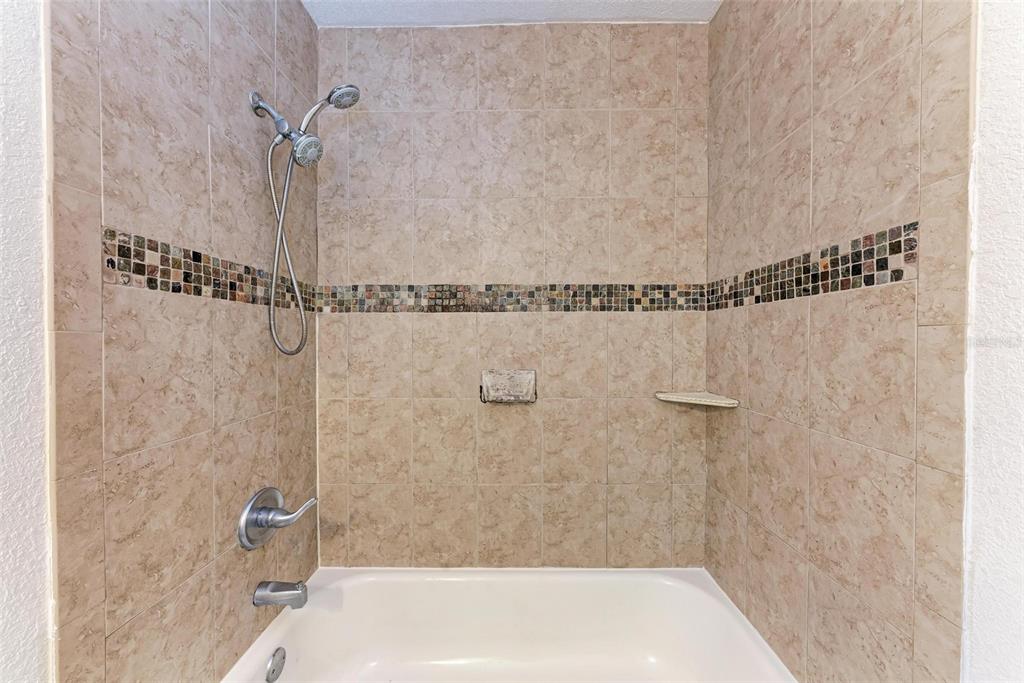 3411 Clark Road, Unit 212 Sarasota, FL 34231 - Photo 15 of 20 a bathroom with a shower and a bathtub