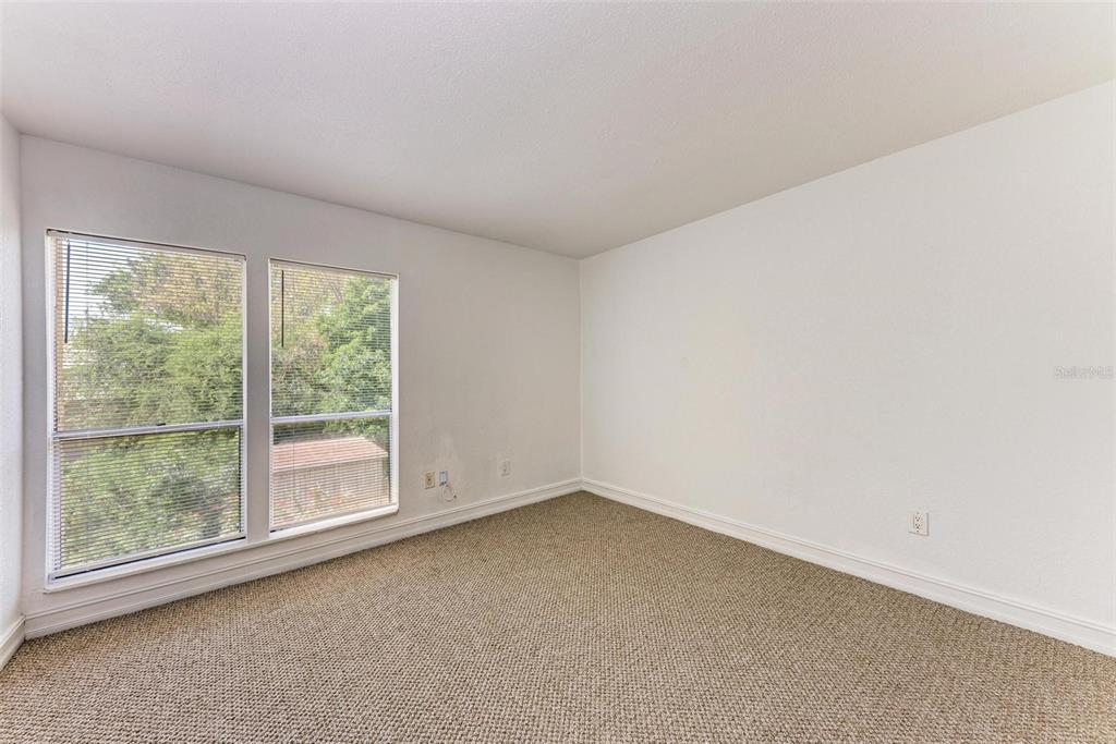 3411 Clark Road, Unit 212 Sarasota, FL 34231 - Photo 16 of 20 an empty room with a window