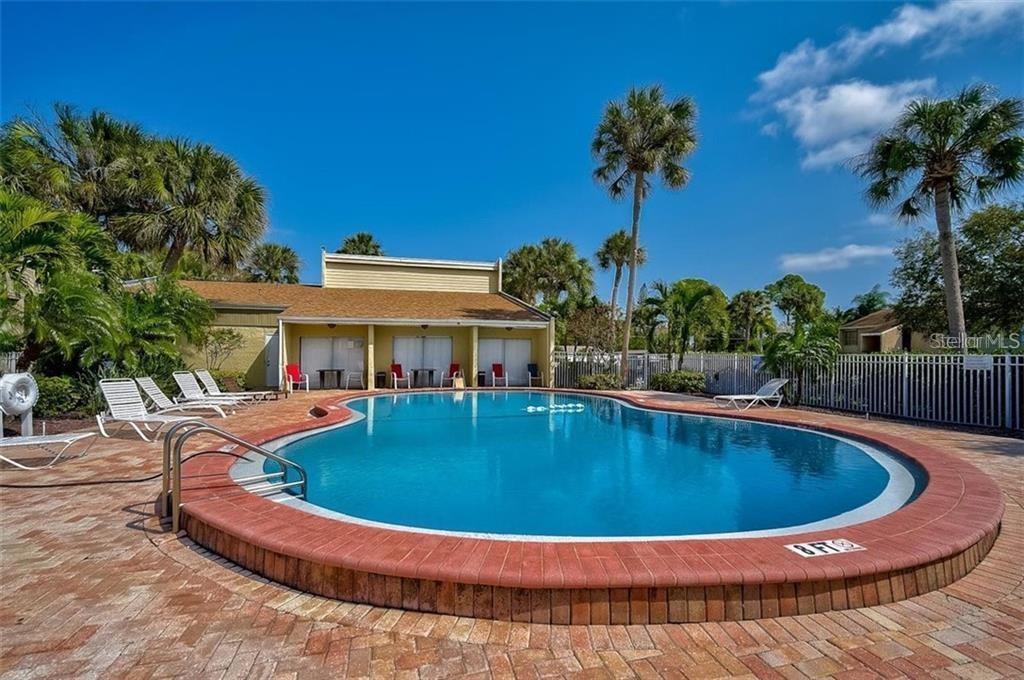3411 Clark Road, Unit 212 Sarasota, FL 34231 - Photo 20 of 20 a view of a swimming pool with a yard
