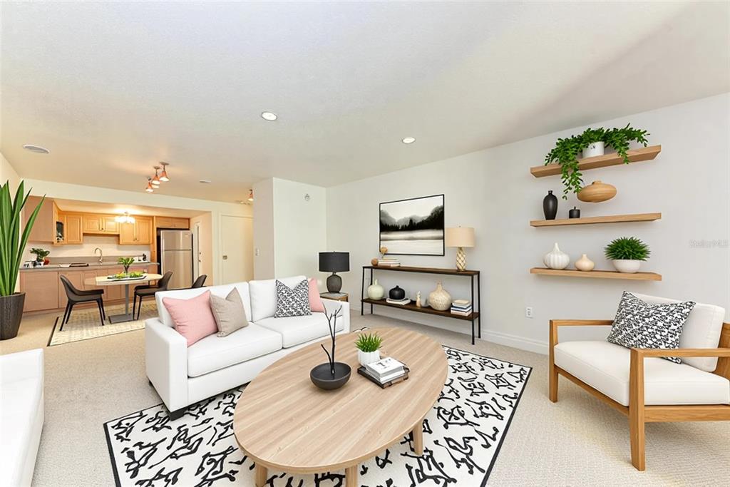3411 Clark Road, Unit 212 Sarasota, FL 34231 - Photo 3 of 20 a living room with furniture and a rug