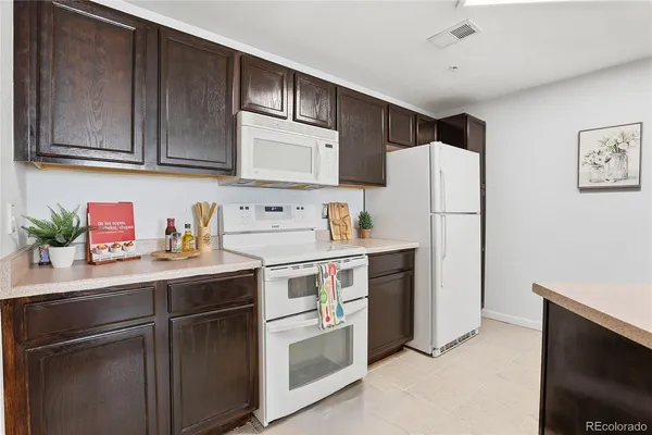 a kitchen with a refrigerator sink and stove